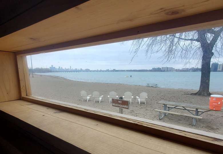 Belle Isle Beach seen from the sauna window, chairs on the sand