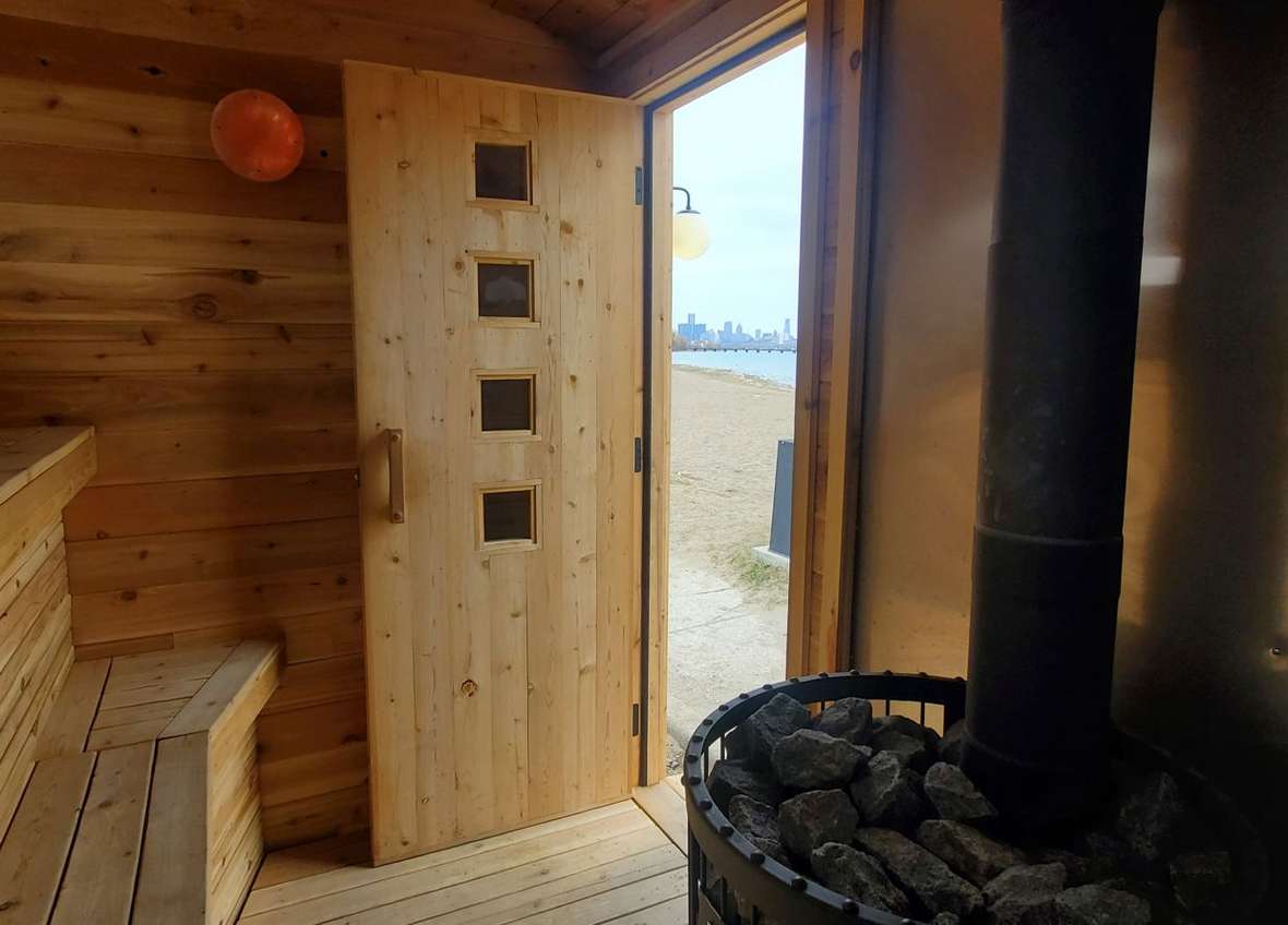Inside the sauna at Belle Isle, door open to the beach and Detroit skyline
