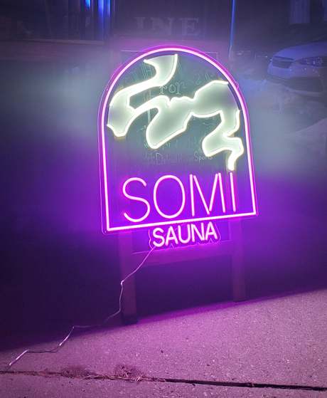 The SOMi neon sign at night