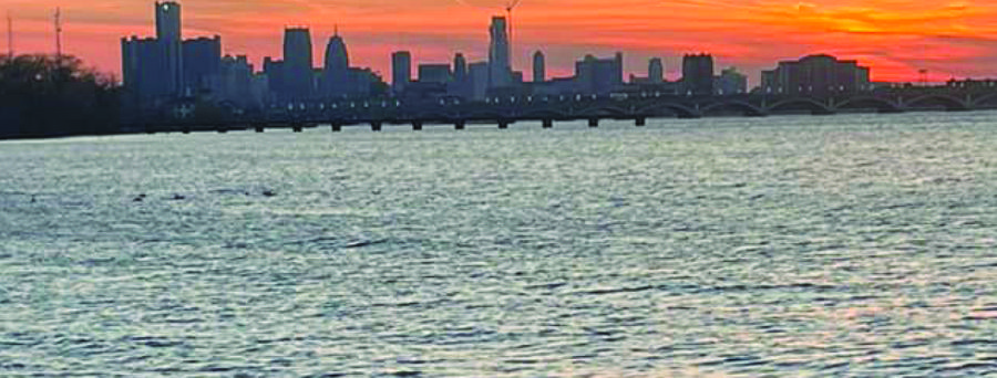 Detroit skyline across the water at sunset