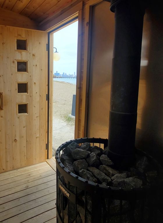 Inside the sauna, door open to the beach